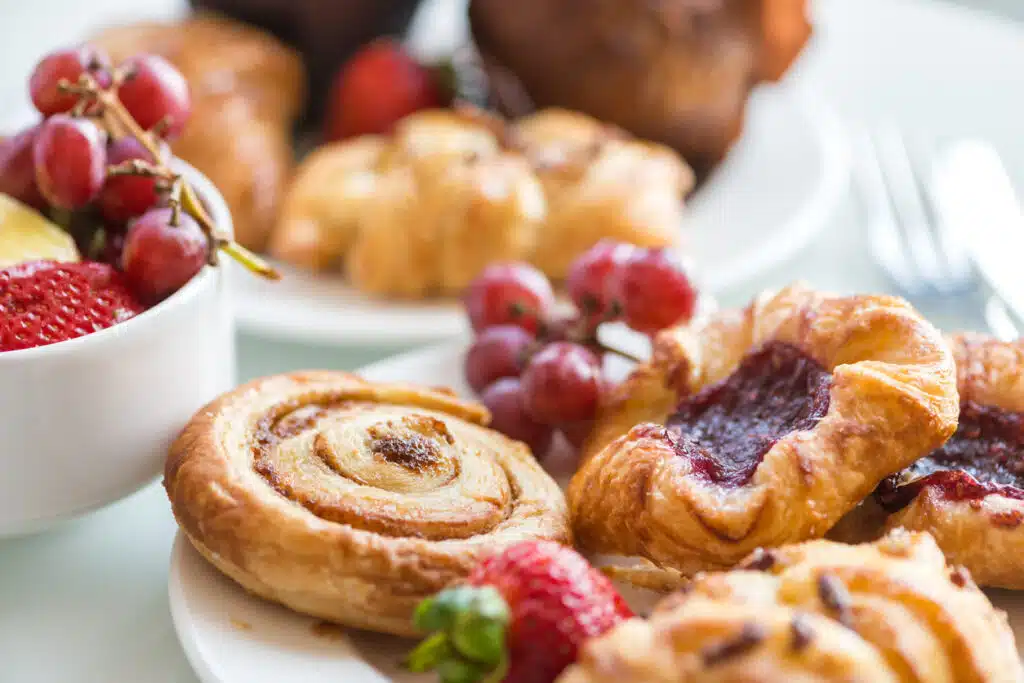 Assortment of pastries and fruit set out for breakfast